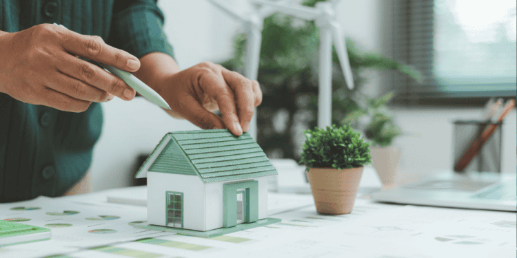 Mano colocando una casa en un modelo de planificación urbana en Soria.