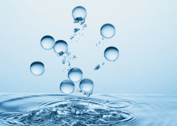 Gotas de agua cayendo y formando ondas en la superficie.